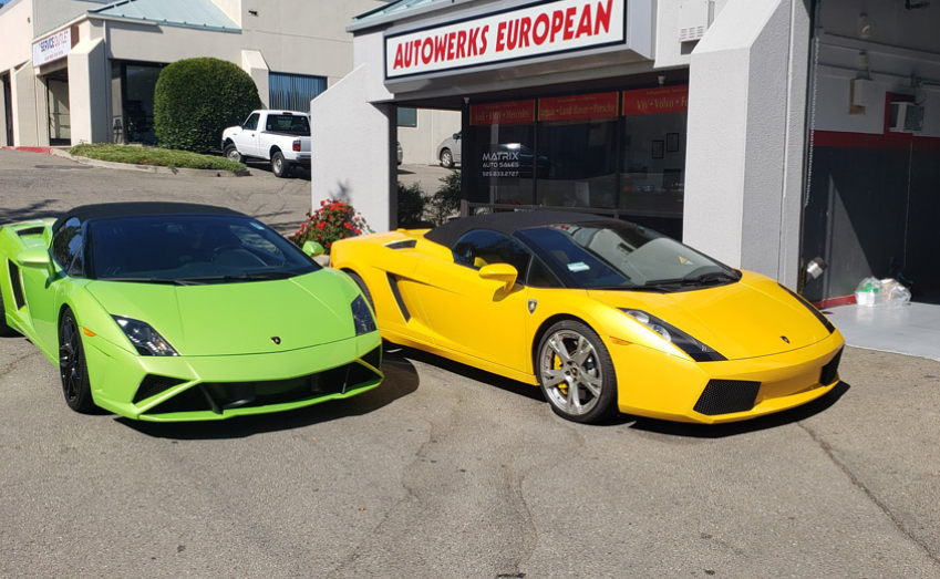 Green and Yellow Lamborghini Gallardos in front of shop